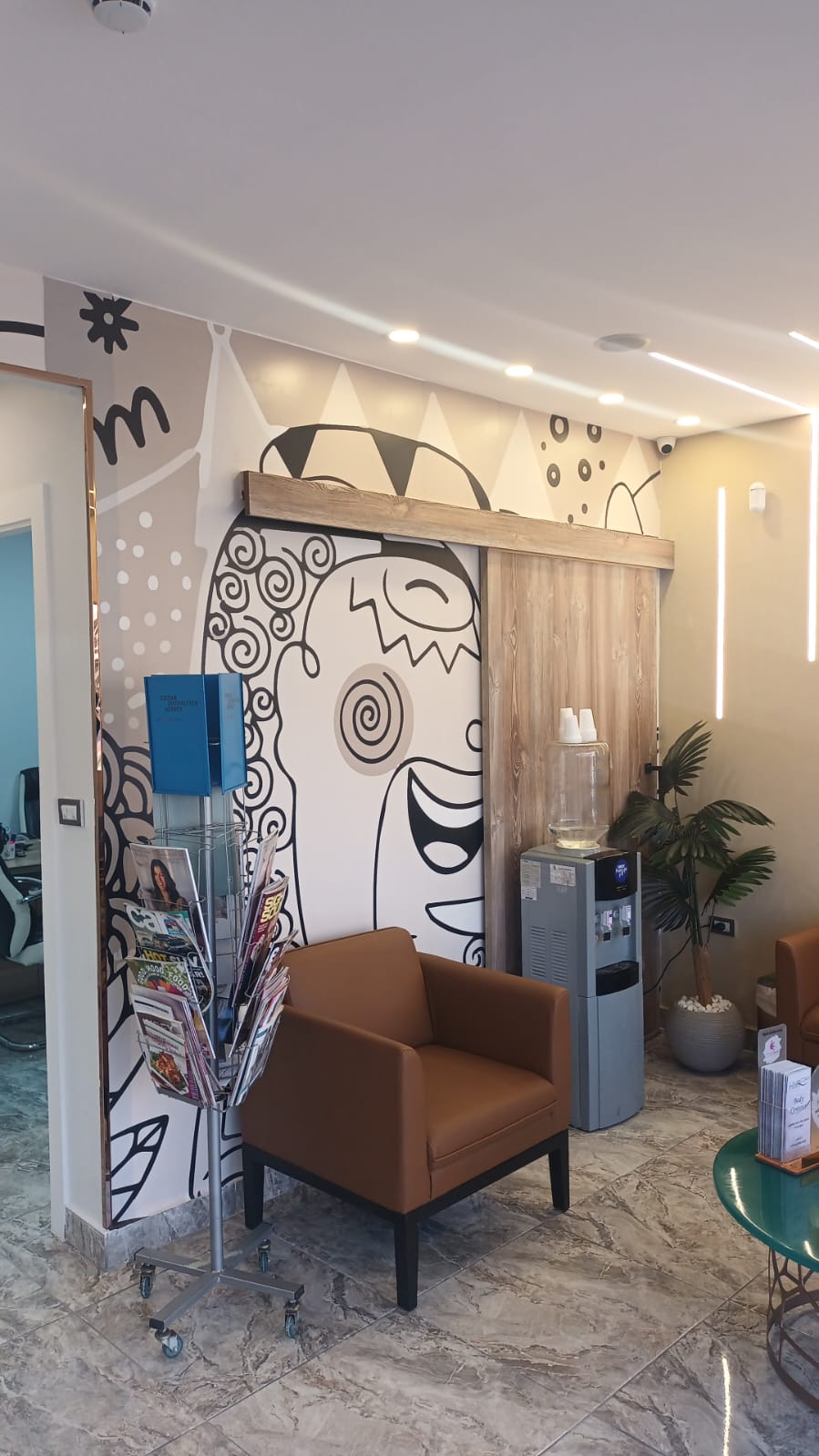Client lounge with hand-painted mural at Gala Clinics Amman