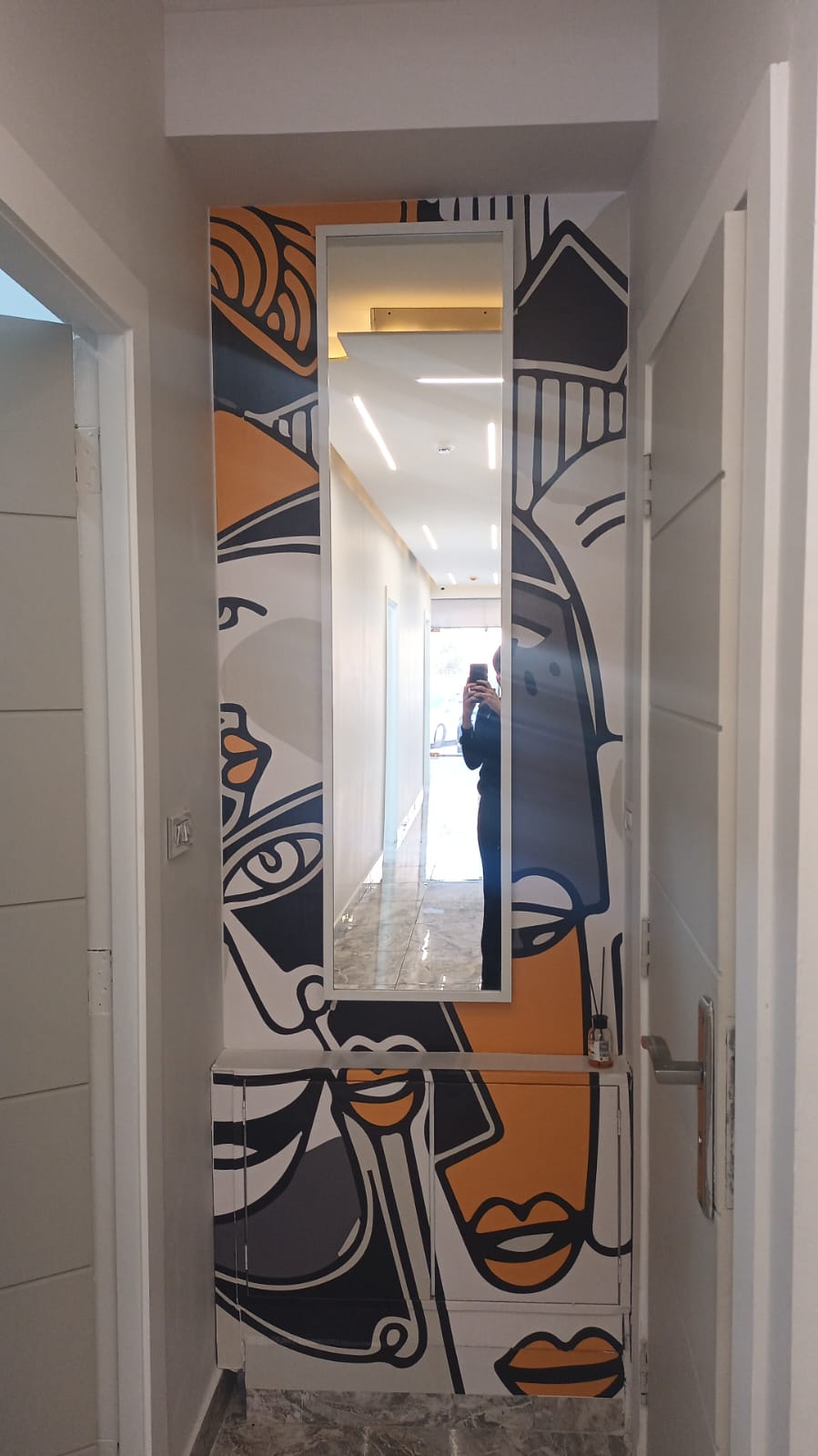 Corridor mirror and mural artwork inside Gala Clinics